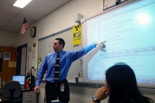 Douglas Poland teaches an AP computer science class at Stone Bridge High School in Ashburn, Va. As a part of Microsoft's TEALS program, professional software engineers help teach the class.