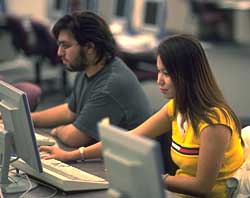 Male and female students working at computers in the computer lab.